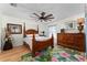 Bedroom with wood floors, a ceiling fan, and a window at 1802 Dalton Dr, The Villages, FL 32162