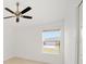 Bright bedroom featuring a ceiling fan and a sunlit window at 2046 Dalecroft Trl, The Villages, FL 32162