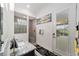 Bathroom featuring a tiled shower, granite counters, and access to the patio at 2050 Biller Cir, The Villages, FL 32163