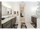 Spacious bathroom with granite countertops, dark wood cabinetry, and tile flooring at 2050 Biller Cir, The Villages, FL 32163