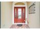 Elegant front door entrance features decorative glass and a welcoming brick pathway at 2050 Biller Cir, The Villages, FL 32163