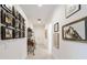 Well-lit hallway with neutral walls, tiled floors and featuring decorative wall art at 2050 Biller Cir, The Villages, FL 32163