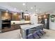 Modern kitchen featuring granite countertops, a center island with barstool seating, and stainless steel appliances at 2050 Biller Cir, The Villages, FL 32163