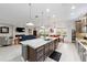 Kitchen island with granite countertops and seating, connecting to the living and dining areas at 2050 Biller Cir, The Villages, FL 32163