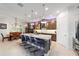 Well-appointed kitchen featuring a center island, pendant lighting, and stainless steel appliances, next to the dining area at 2050 Biller Cir, The Villages, FL 32163