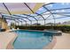 Screened pool with hot tub and sunshade provides the perfect outdoor relaxation and entertainment space at 2050 Biller Cir, The Villages, FL 32163