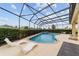 Gorgeous pool area with a hot tub, comfortable loungers, and a screened-in enclosure at 2050 Biller Cir, The Villages, FL 32163