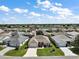 Aerial view of a well-maintained home with a manicured lawn and garden beds on a cul-de-sac at 2114 Gerardo Ave, The Villages, FL 32159