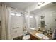 Bathroom features tiled shower over tub, granite counters, and recessed lighting at 2114 Gerardo Ave, The Villages, FL 32159