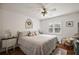 Bedroom featuring hardwood floors, bright natural light, and neutral decor with beach accents at 2114 Gerardo Ave, The Villages, FL 32159