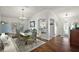 Bright dining room featuring hardwood floors and an open view into kitchen at 2114 Gerardo Ave, The Villages, FL 32159