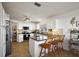 Well-lit kitchen featuring white cabinets and granite countertops with seating at 2114 Gerardo Ave, The Villages, FL 32159