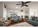 Cozy living room featuring hardwood floors, a ceiling fan, and ample seating at 2114 Gerardo Ave, The Villages, FL 32159