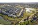 Aerial view of a residential community with golf course, lakes, and lush landscaping at 2124 Biller Cir, The Villages, FL 32163