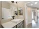 Elegant bathroom with a large mirror, vanity sink, and doorway view to the shower and hallway at 2124 Biller Cir, The Villages, FL 32163