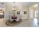 Charming dining room with a round table, elegant chandelier, and neutral décor at 2124 Biller Cir, The Villages, FL 32163