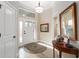 Bright foyer with wood-look floors, transom window, and decorative front door at 2124 Biller Cir, The Villages, FL 32163