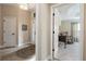 Inviting foyer flows to a carpeted room with a rocking chair and hallway with tile floor and entry door at 2124 Biller Cir, The Villages, FL 32163