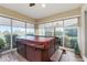 Hot tub in sun room with ceiling fans, windows, and view of greenery at 2124 Biller Cir, The Villages, FL 32163