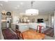 Open kitchen featuring stainless steel appliances, kitchen island, and seamless flow into the living room at 2124 Biller Cir, The Villages, FL 32163