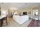 Open-concept living room with tile floors, neutral walls, and abundant natural light at 2124 Biller Cir, The Villages, FL 32163