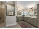 Well-lit main bathroom featuring double sinks, quartz countertops, framed mirrors, and neutral color palette at 2124 Biller Cir, The Villages, FL 32163