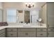 Beautiful bathroom featuring a stylish sink, vanity, mirror and cabinetry with plentiful storage at 2124 Biller Cir, The Villages, FL 32163