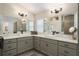 Bright main bathroom with double vanity sinks, ample counter space, and modern light fixtures at 2124 Biller Cir, The Villages, FL 32163