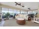 Bright sun room featuring a white couch, ceiling fans, large windows, and a hot tub at 2124 Biller Cir, The Villages, FL 32163