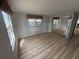 This bedroom features wood-look floors and mirrored closet doors at 22 Big Tree Dr, Fruitland Park, FL 34731