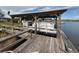 Covered boat dock with seating and lake view at 22 Big Tree Dr, Fruitland Park, FL 34731