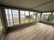 Enclosed porch with wood floors and windows with a view of the canal and boat docks at 22 Big Tree Dr, Fruitland Park, FL 34731