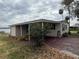 Single story home featuring a covered carport and view of the lake at 22 Big Tree Dr, Fruitland Park, FL 34731