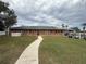 Community clubhouse with parking area at 22 Big Tree Dr, Fruitland Park, FL 34731