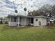 Exterior of home with covered parking and screened porch at 22 Big Tree Dr, Fruitland Park, FL 34731