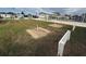 Horseshoe pits on grass near covered picnic benches with homes, shuffleboard courts, and parked cars behind at 22 Big Tree Dr, Fruitland Park, FL 34731