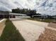 Uncovered shuffleboard courts with view of covered benches and nearby homes in the community at 22 Big Tree Dr, Fruitland Park, FL 34731