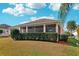 Exterior of home featuring well-maintained landscaping, lawn and screened lanai at 2311 Bramble Ter, The Villages, FL 32162