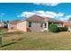 Exterior view of home featuring well-maintained lawn and mature landscaping at 2311 Bramble Ter, The Villages, FL 32162