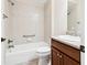 Cozy bathroom featuring shower-tub combo with neutral tile surround and a granite-topped vanity at 2311 Bramble Ter, The Villages, FL 32162