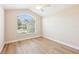 Comfortable bedroom featuring a large window for natural light and beautiful wood flooring at 2311 Bramble Ter, The Villages, FL 32162