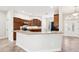 Kitchen area featuring granite countertops, stainless appliances, wood cabinets, and tile floor at 2311 Bramble Ter, The Villages, FL 32162