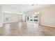 Open living room featuring tile floors, a ceiling fan, and sliding glass doors to the lanai at 2311 Bramble Ter, The Villages, FL 32162