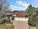 A high angle view featuring the home's front exterior, landscaping, and driveway at 2360 Unity Ter, The Villages, FL 32162