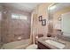 Bathroom featuring a shower-tub combo with tile surround, a granite countertop, and decorative accents at 2360 Unity Ter, The Villages, FL 32162