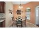 Charming breakfast nook features a decorative chandelier, a round table, and a window at 2360 Unity Ter, The Villages, FL 32162