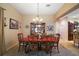 Elegant dining room features a chandelier, a large hutch, and a table with chairs at 2360 Unity Ter, The Villages, FL 32162