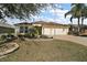 Charming home featuring a well-maintained lawn, complemented by a spacious two-car garage and neatly trimmed landscaping at 2360 Unity Ter, The Villages, FL 32162