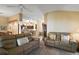 Comfortable living room with ceiling fan, view into kitchen, and neutral walls at 2360 Unity Ter, The Villages, FL 32162