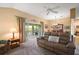 Inviting living room featuring a sliding glass door to the outdoor space and a sofa at 2360 Unity Ter, The Villages, FL 32162